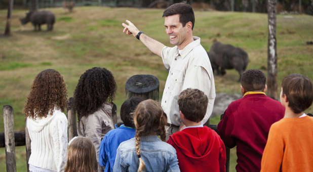 Teacher and field and students