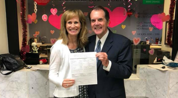 Faye Tharp and Rich Bott show off their marriage license.